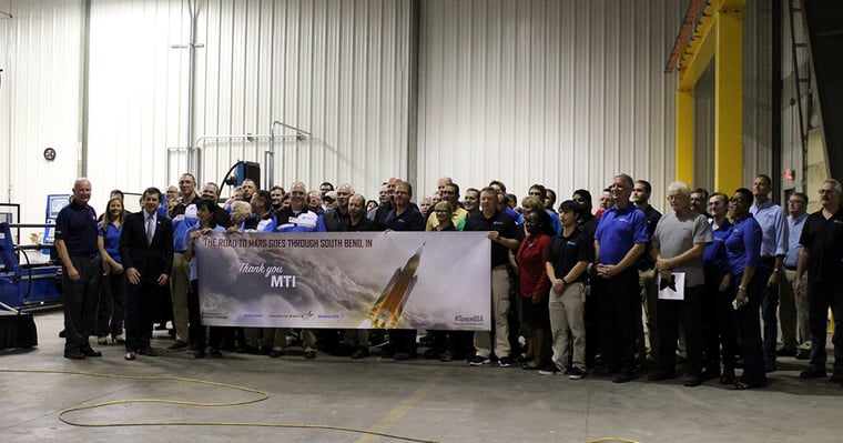 NASA and other key members present MTI with a banner for their efforts in the journey to Mars.